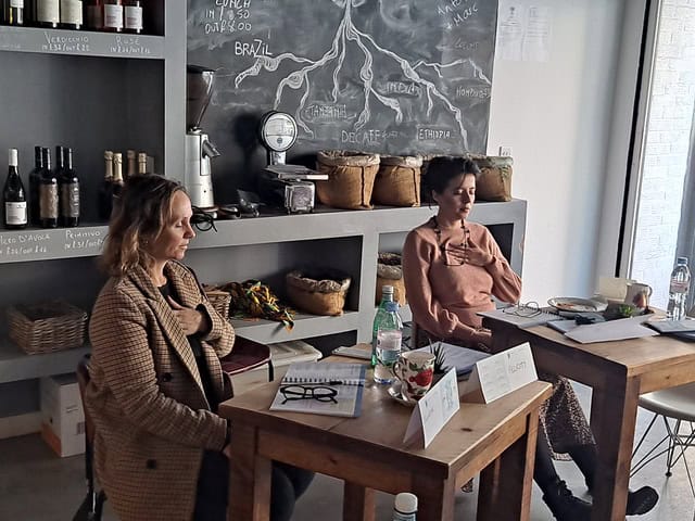 Two women meditate at cafe or deli tables